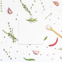 Blank notepad pages with greens herbs and spices photo