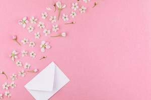 Concept of love letter with envelope and flowers photo