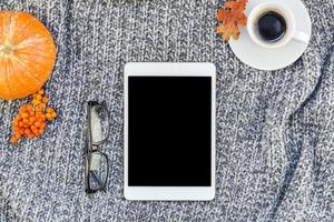 Home workplace with coffee cup on knitted plaid photo