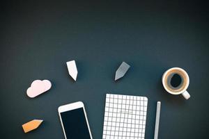 Workplace desk with smartphone and coffee cup photo