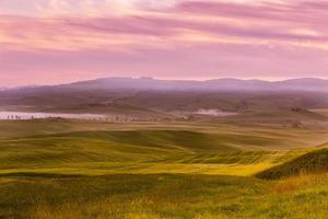 Morning fog view on farmland in Tuscany, Italy photo