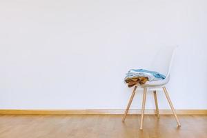 Indoors flat wall mockup with Clothes on Chair photo