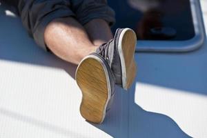 A pair of hairy man legs in pants and topsiders photo