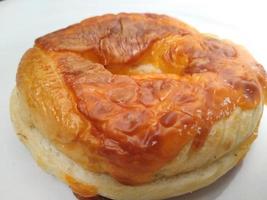 Morning breakfast a delicious bread or burger on a white plate. Good for used on business related to food, pastry, bakery, restaurant. photo