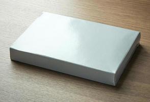 blank gray paper box on dark wood background photo