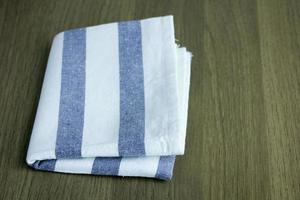 folded napkin on wooden table photo