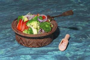 Healthy food vegetable broccoli salad in bowl on wood background. photo