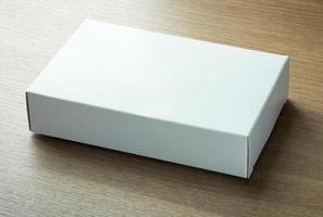 blank white paper box on dark wood background photo