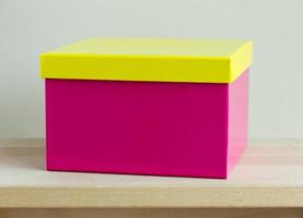 blank colorful paper box on wooden table photo