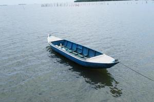 Pangkajene and Kepulauan, South Sulawesi, Indonesia - May 14, 2022, Empty boat is in the middle of the sea photo