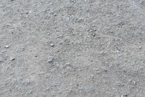 Background of asphalt surface with dust and gravel photo