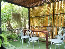 A quiet corner to read books in the garden and surrounded by green trees photo