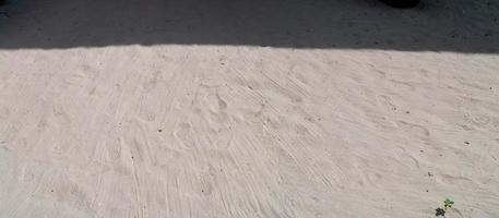 The sand floor  with the shadow of the sun on top With the footprints of people on the sand, The image of panorama view photo