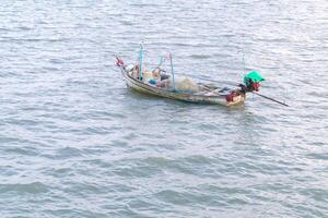 Fishing boat parking on sea with wind blows be sea waves photo