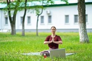 Mother and daughter doing yoga. woman and child training in the park.  outdoor sports. healthy sport lifestyle, chaturanga pose. well being,  mindfulness concept,watching video tutorial online on laptop 8497445 Stock  Photo at