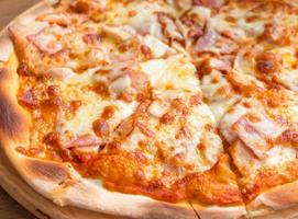 pizza slices on wooden plate photo