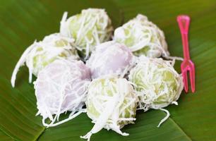 sweet balls on banana leaf photo