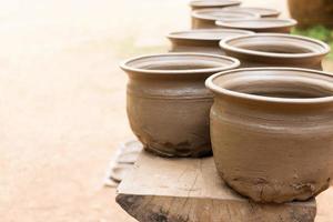 drying earthenware on wooden shelf photo