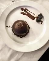 A round minimalistic Sacher-torte on a white plate photo