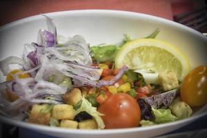 A served criolla salad on a white plate photo