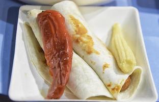 Two quesadillas with vegetables on a white plate photo