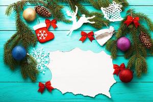Christmas tree and card with copy space and accessories. Top view photo