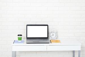 Education accessories on the table near brick wall. Empty computer and mobile screen with place for text. photo