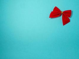 New Year card. Red bow. Christmas card on a blue background. photo