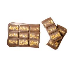 Milk chocolate bar with nuts on a white background. photo