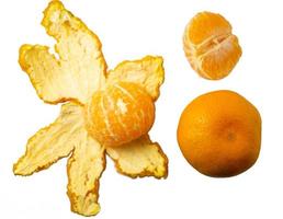 Mandarin peel.Unpeeled tangerine, fruit wedges. photo