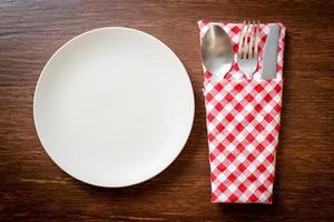 empty plate or dish with knife, fork and spoon photo