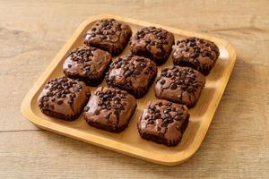 dark chocolate brownies topped by chocolate chips photo