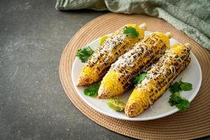 barbecue and grilled corn with cheese and lime photo