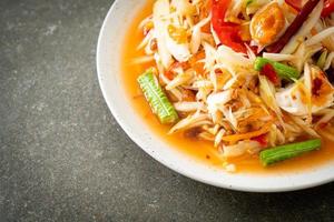 Som Tum - Thai Spicy green papaya salad with salty eggs photo