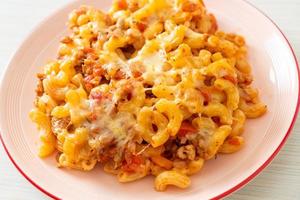 homemade macaroni bolognese with cheese photo