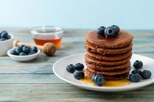 chocolate pancake stack with blueberry and honey photo