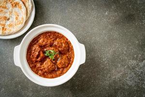 chicken tikka masala spicy curry meat food with roti or naan bread photo