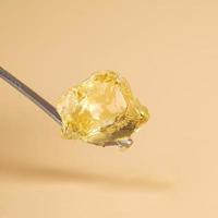 a piece of concentrated cannabis wax , high thc golden dab photo