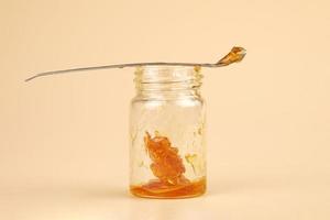 golden cannabis extract, marijuana bottle with resin and dabbing stick photo