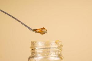 golden cannabis extract, marijuana  resin and dabbing stick photo