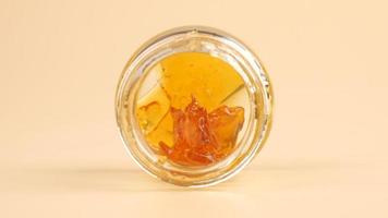 cannabis extract rosin with high thc in a glass bottle photo