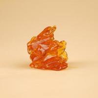 amber yellow piece of cannabis wax with high thc close up photo