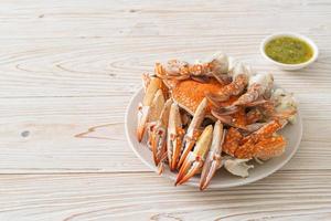 Steamed blue crab with spicy seafood sauce photo