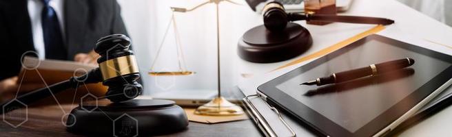 Male lawyer working with contract papers and wooden gavel on tabel in courtroom. justice and law ,attorney, court judge, concept. photo