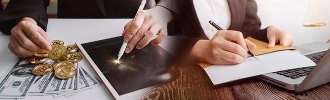 Business and lawyers discussing contract papers with brass scale on desk in office. Law, legal services, advice, justice and law concept picture with film grain effect photo