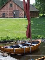 Fredrikstad, Norway. May 27, 2022. A wooden rowboat tied to the dock at Isegran in Fredrikstad, Norway. photo