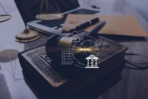 Justice and law concept.Male judge in a courtroom with the gavel, working with, computer and docking keyboard, eyeglasses, on table in morning light photo