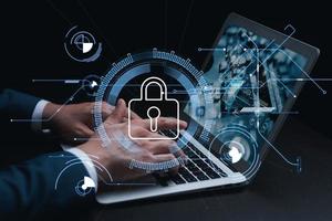 Cybersecurity and privacy concepts to protect data. Lock icon and internet network security technology. Businessmen protecting personal data on laptop and virtual interfaces. photo