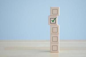 Elections and Voting, Vote, to do list, checklist, Task list, Exam ,Survey and assessment concept. Check mark on wooden block and blank check box on wooden cubes. photo