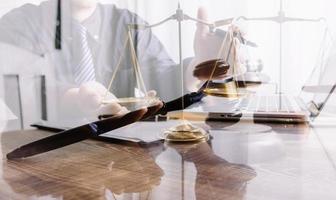 Business and lawyers discussing contract papers with brass scale on desk in office. Law, legal services, advice, justice and law concept picture with film grain effect photo